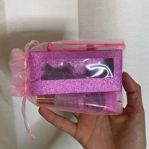 lashes,tube of lipgloss,eyelash brush,eyelash tweezers